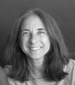 A black and white photo of a woman smiling.