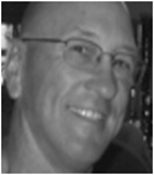 A black and white photo of a man with glasses.